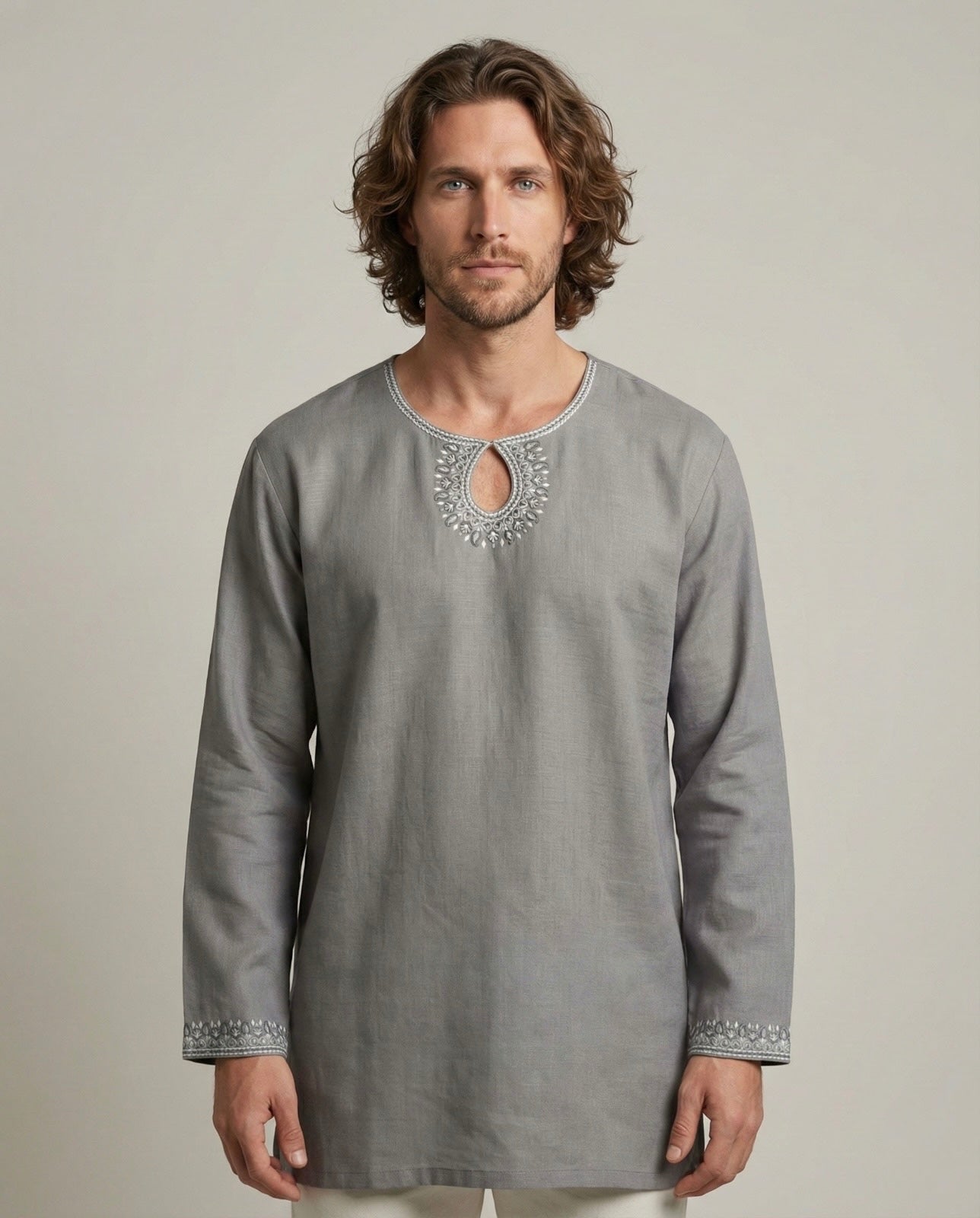 Man wearing a gray embroidered long-sleeve kurta against a plain background