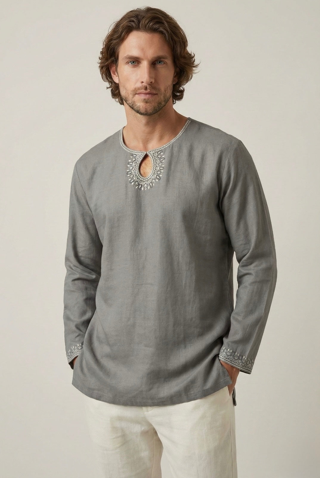 Man wearing a grey embroidered kurta made from soft-touch cotton.