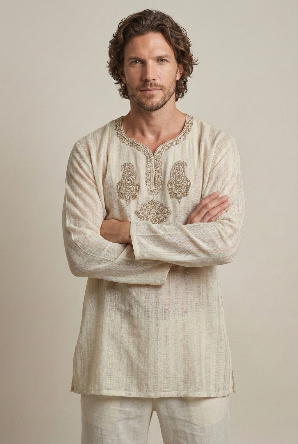 Man wearing a beige embroidered kurta made from lightweight premium cotton.